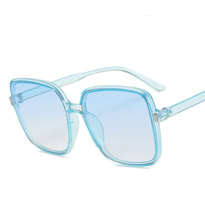 Big square sunglasses in translucent blue color with a stylish design.