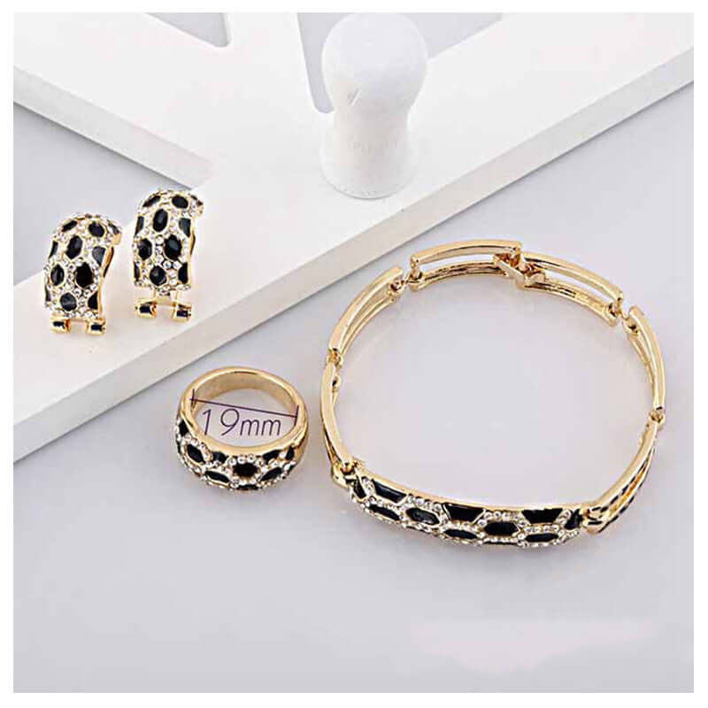 Costume jewelry sets for women including earrings, bracelet, and ring showcased on a display.