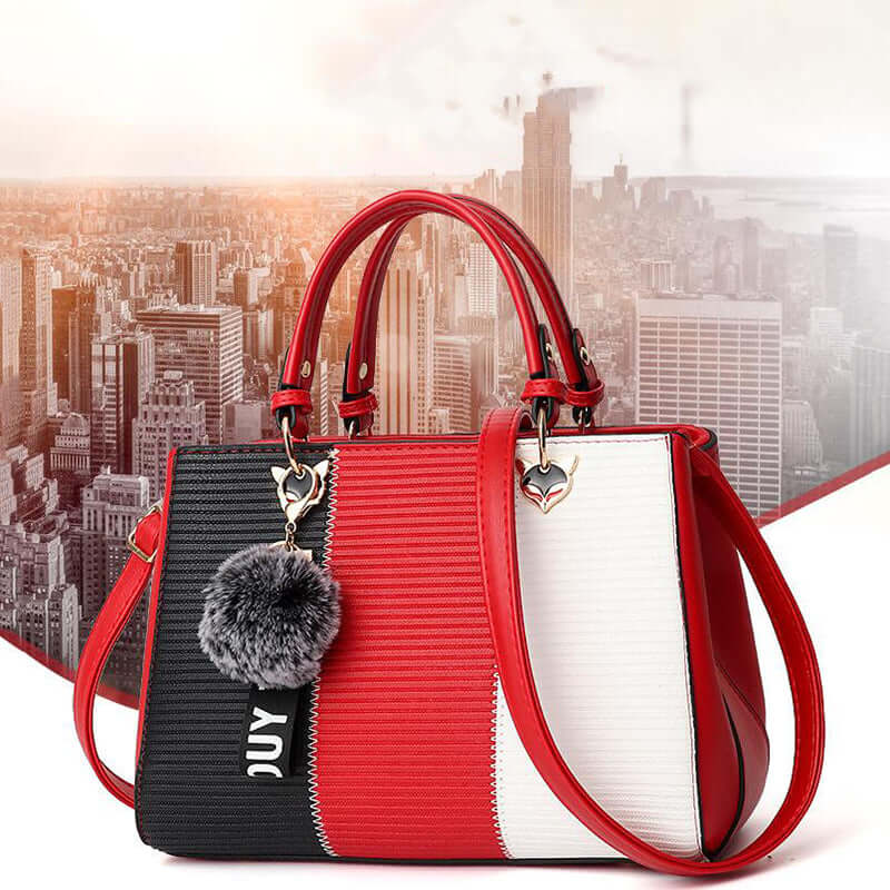 Patchwork women's shoulder bag in red, black, and white with stylish pom-pom and unique design