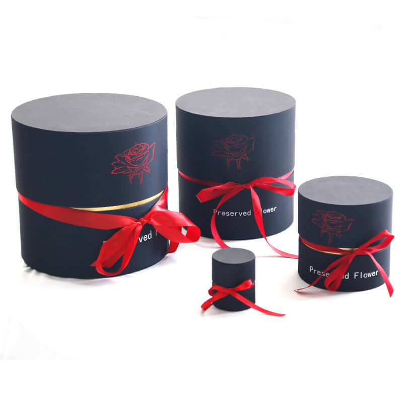 Preserved real roses gift box in various sizes with elegant red ribbons, perfect for special occasions.