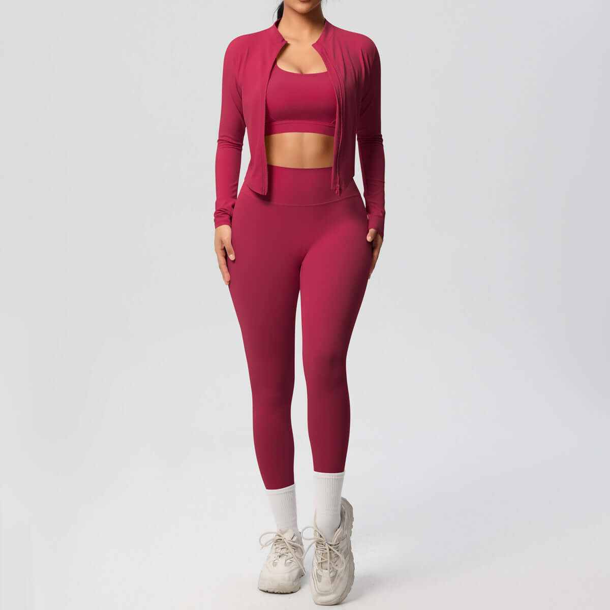 Women's yoga outfit set featuring a matching spandex coat, crop top, and trousers in a stylish maroon color.
