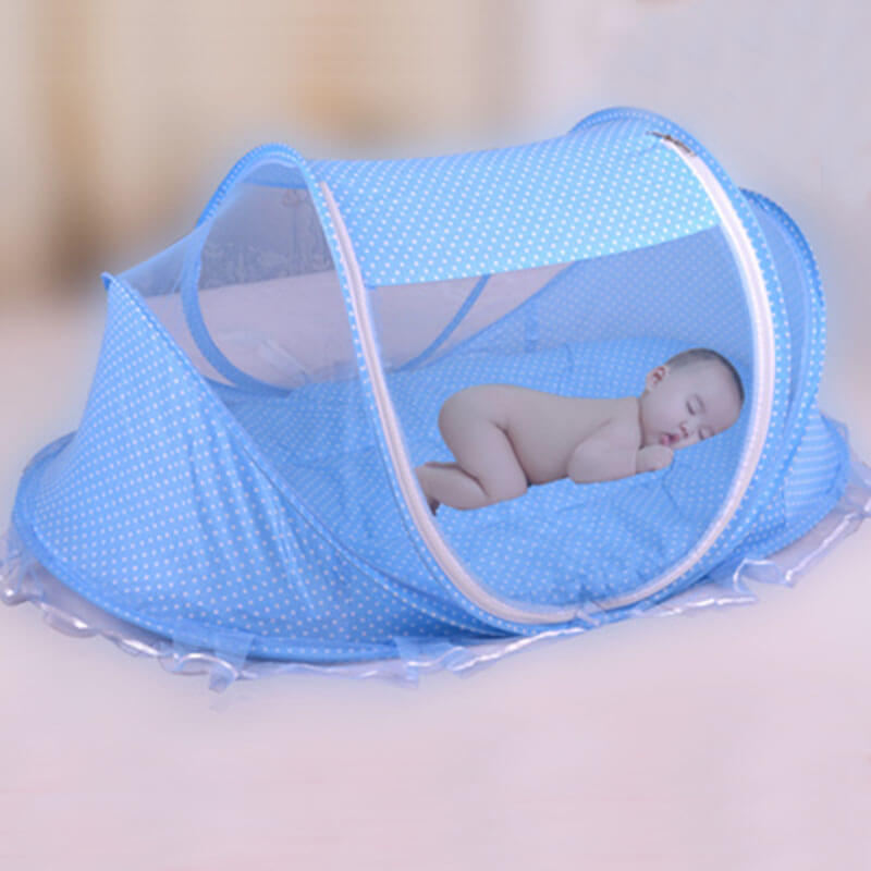 Portable baby mosquito net bed with a sleeping infant inside, designed for safety and comfort during outdoor use.