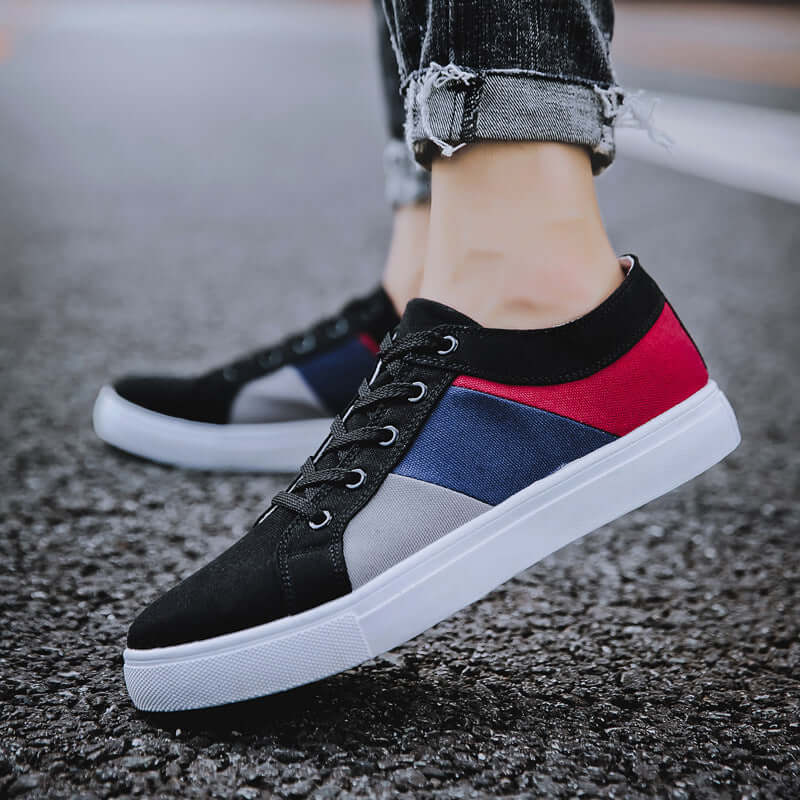 Classic canvas sneakers for men and women, featuring a black, red, and blue design, perfect for casual wear.