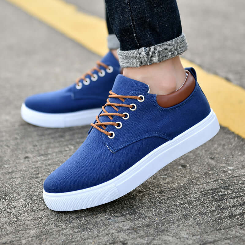 Classic canvas sneakers in blue color with brown accents, ideal for casual outings and daily wear.
