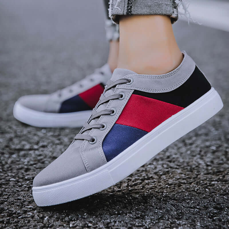 classic canvas sneakers in gray with red and navy accents, perfect for casual wear for men and women.