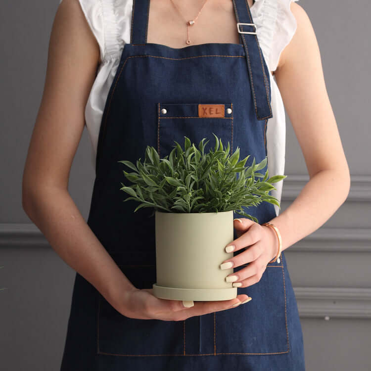 Nordic ceramic flowerpot with drainage hole showcasing a plant, perfect for indoor or outdoor use.