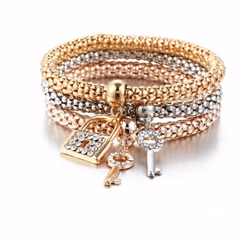 Lock and key bracelet set featuring rhinestone accents in gold and silver, perfect for couples and meaningful gifting.
