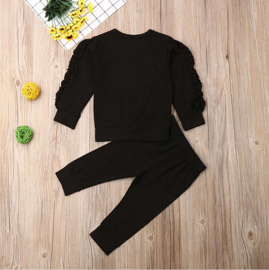 Kids ruffle sweatshirt set featuring soft cotton jumper and pants for boys and girls in black.