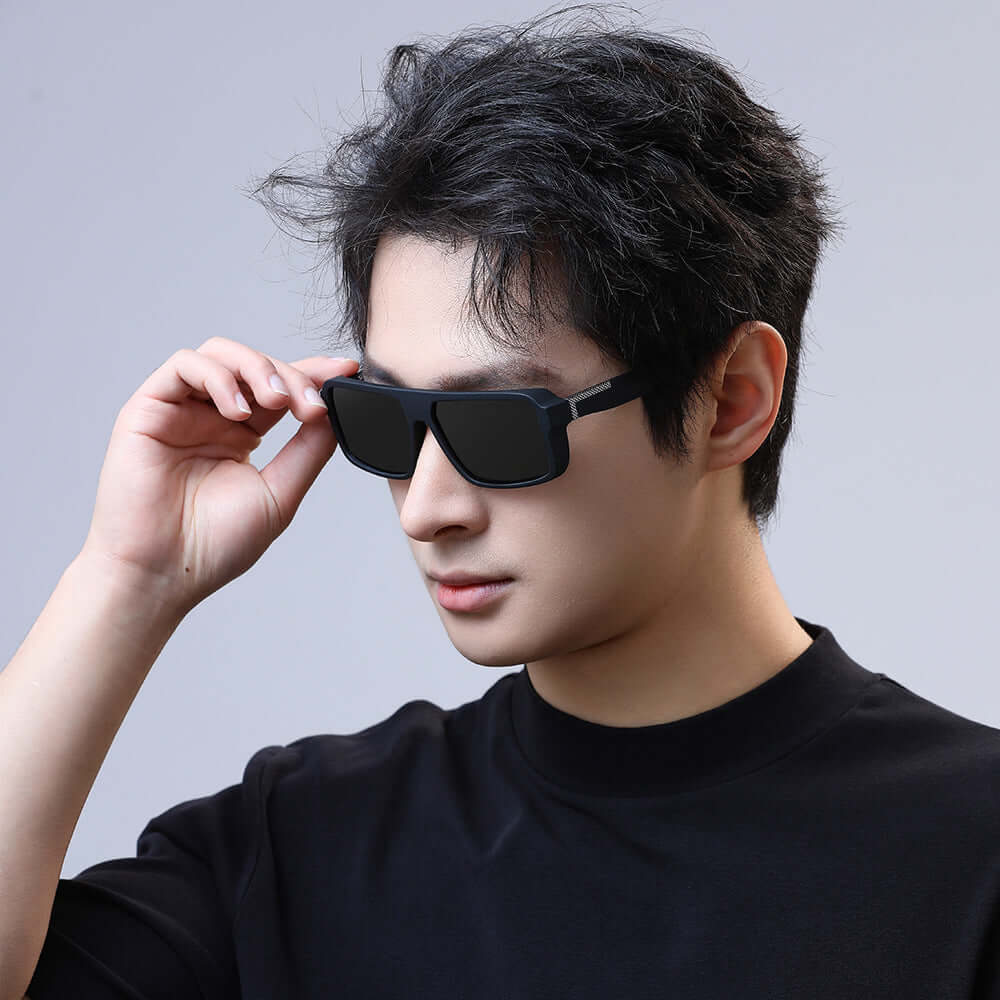 Polarized UV400 sunglasses for men worn by a young man, showcasing anti-glare lenses and stylish frame.