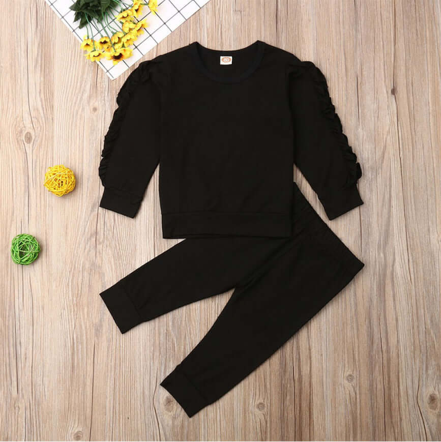 Kids ruffle sweatshirt set featuring a black cotton jumper and matching pants, perfect for boys and girls.
