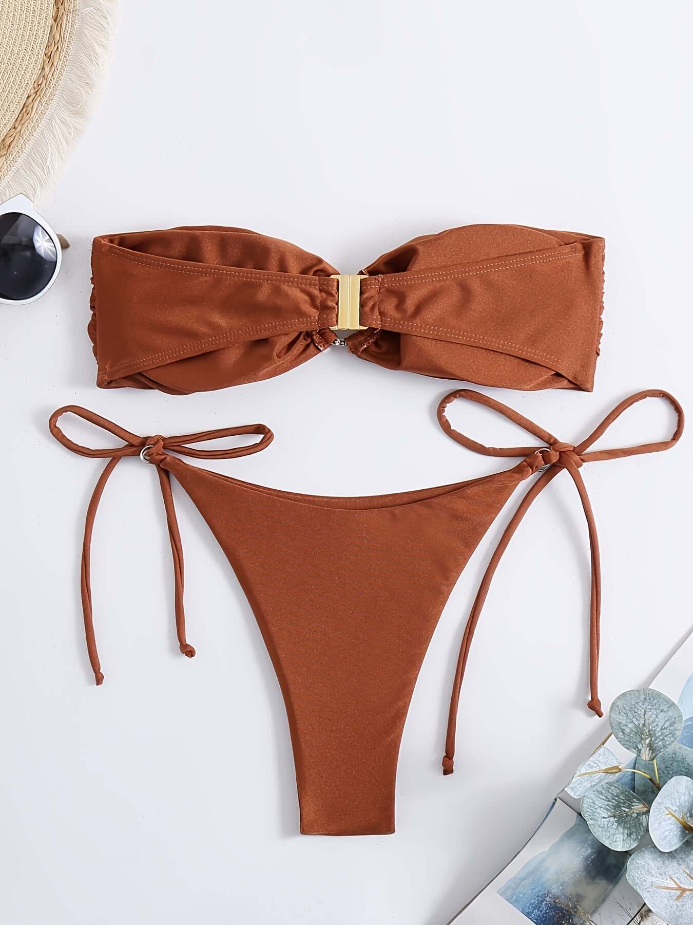 Strapless bandeau bikini set in brown featuring ring detail and tie-side bottoms.
