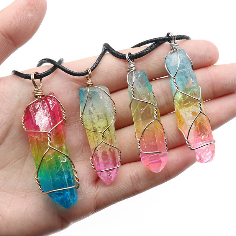 Colorful tree of life crystal necklace pendants on a hand, showcasing vibrant stone designs for women.
