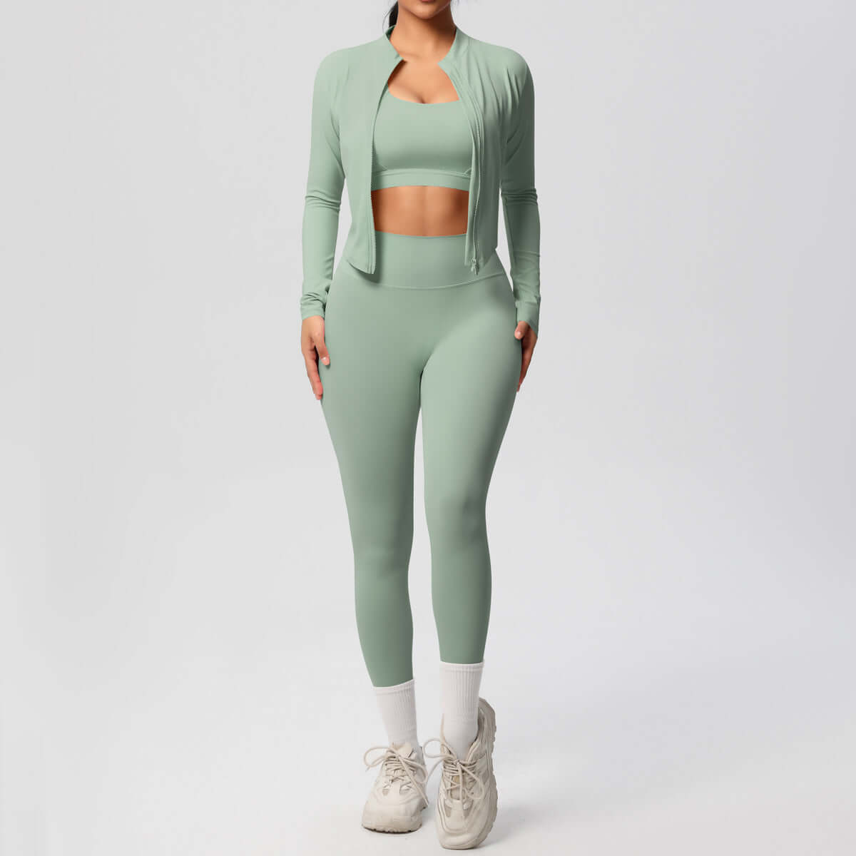 Women's yoga outfit set featuring a spandex activewear coat, top, and trousers in a stylish green design.