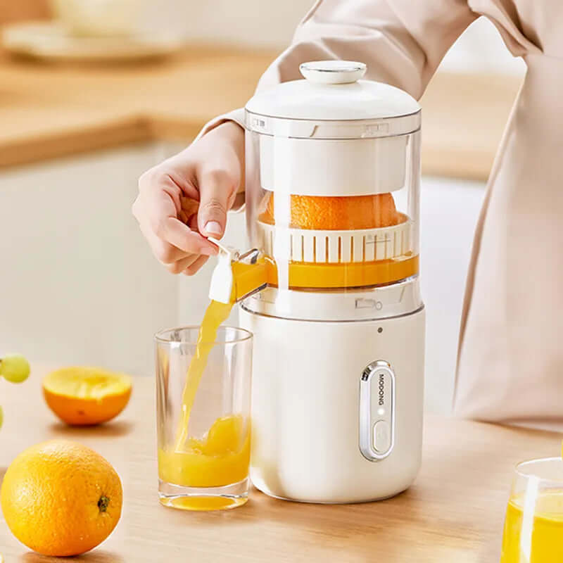 Wireless electric orange juicer in action, squeezing fresh juice into a glass, showcasing USB-C charging and BPA-free design.