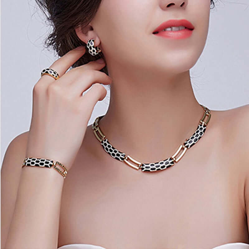 Costume jewelry sets for women featuring a stylish necklace, earrings, and bracelet in a modern design.
