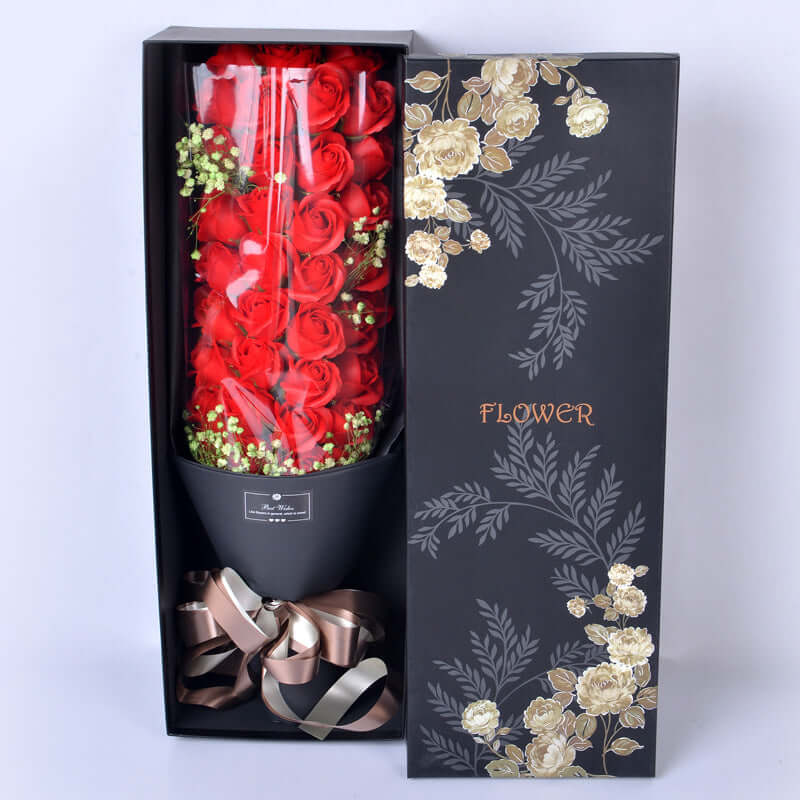 Luxury floral gift bouquet in an elegant box featuring red roses and decorative ribbons, perfect for special occasions.