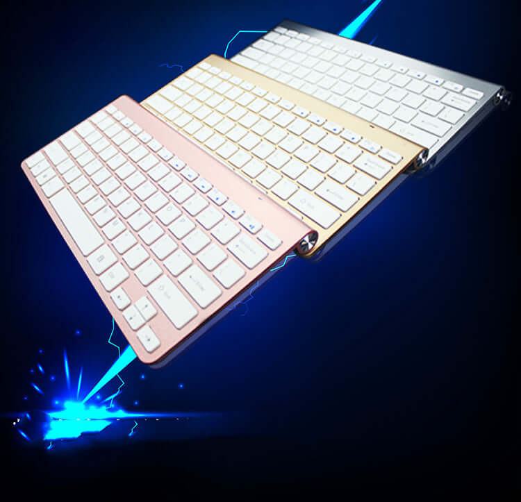 Wireless Bluetooth keyboard mouse combo in pink, gold, and silver colors against a dark background with blue accents.