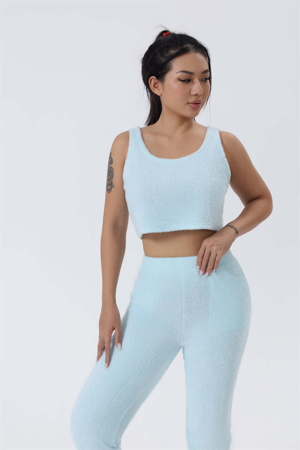 women's cozy loungewear set in soft blue fabric featuring a crop top and fitted pants