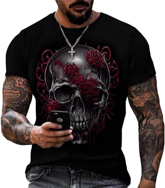 Man wearing a printed short sleeve skull head graphic t-shirt with roses on a black background.