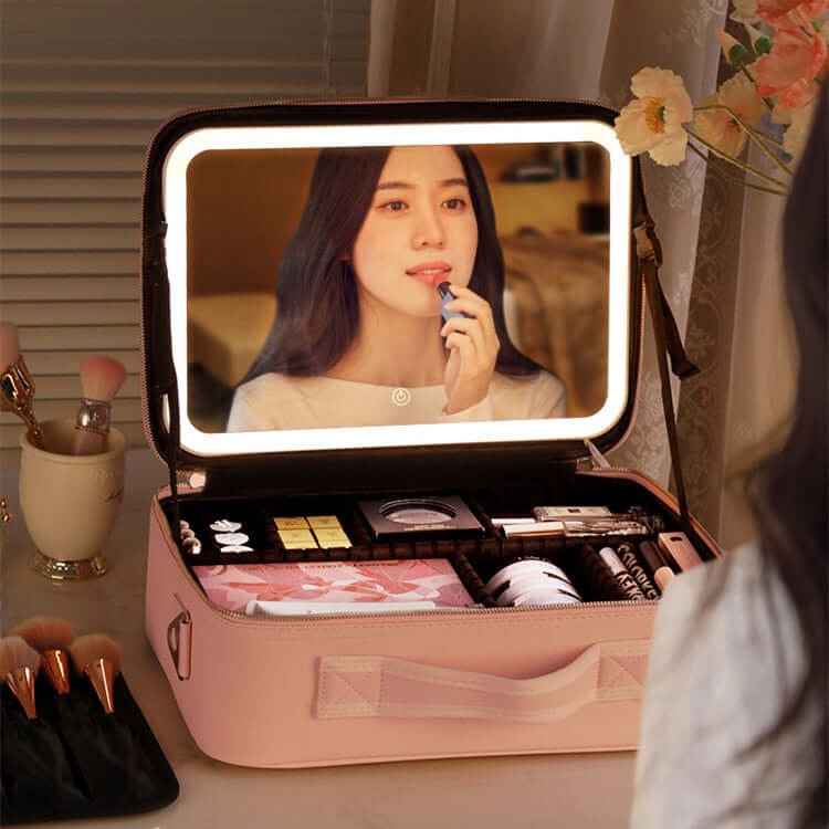 Smart LED lighted makeup case open with 4K mirror and adjustable fill light, featuring cosmetics and a user applying lipstick.
