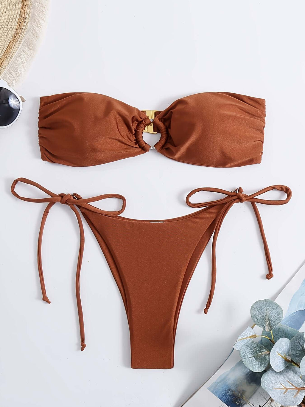 Strapless bandeau bikini set in rust color with ring detail and adjustable tie-side bottoms.