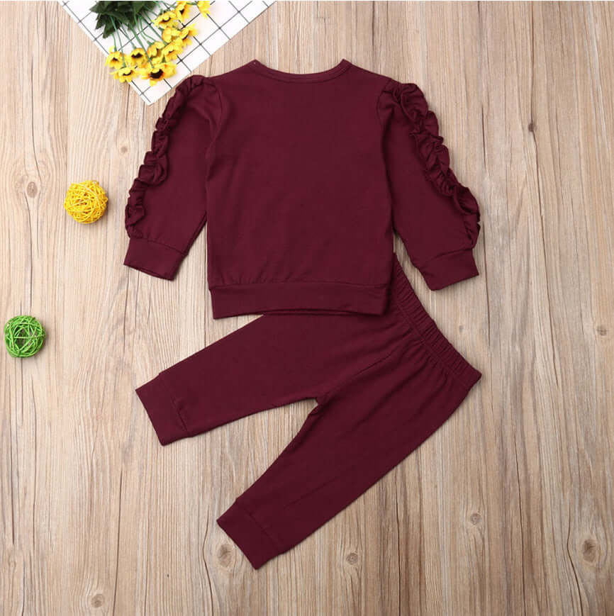 Kids ruffle sweatshirt set featuring a maroon cotton jumper with ruffle sleeves and matching pants, perfect for playdates.