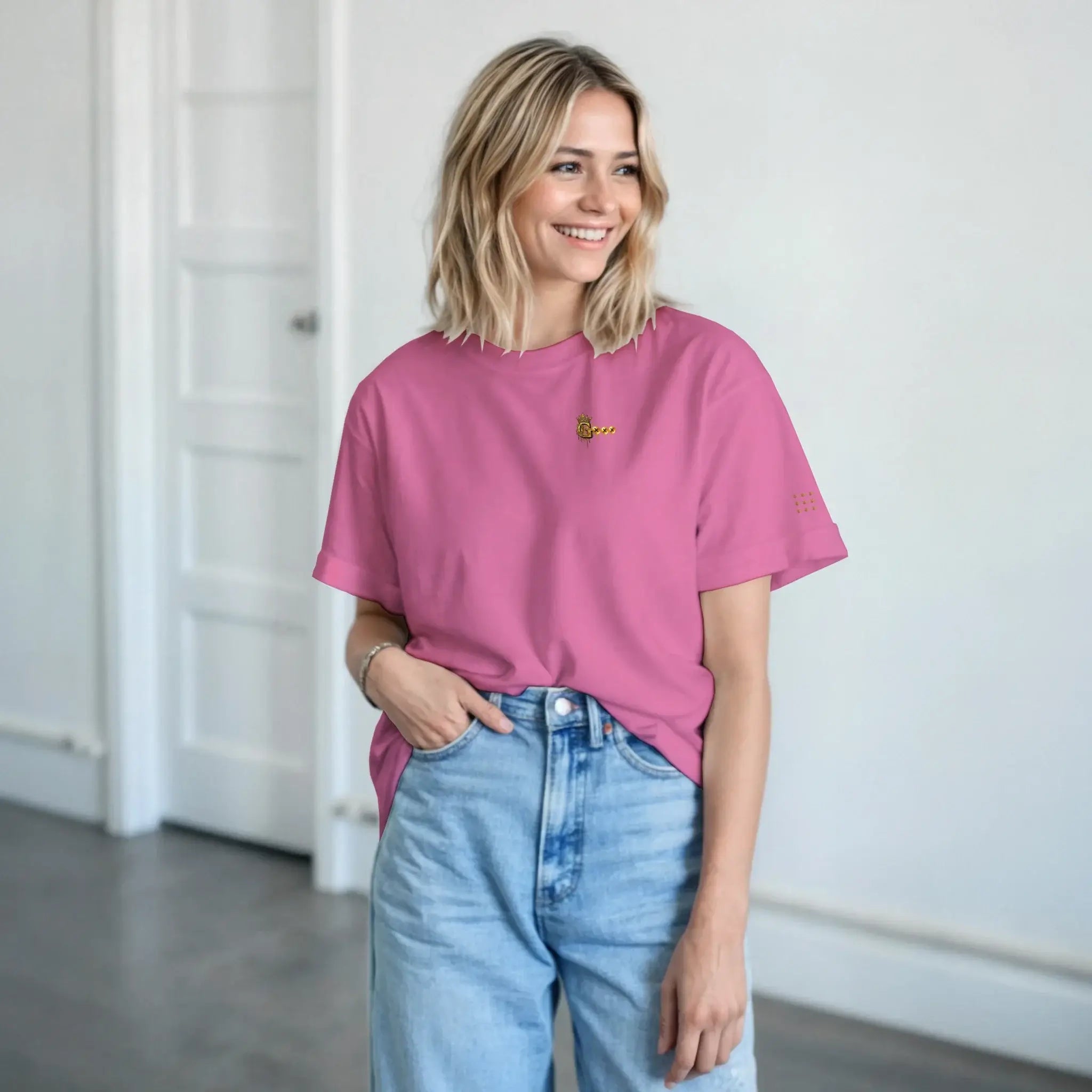 Model wearing a heavyweight unisex t-shirt in pink with a relaxed fit and casual style.