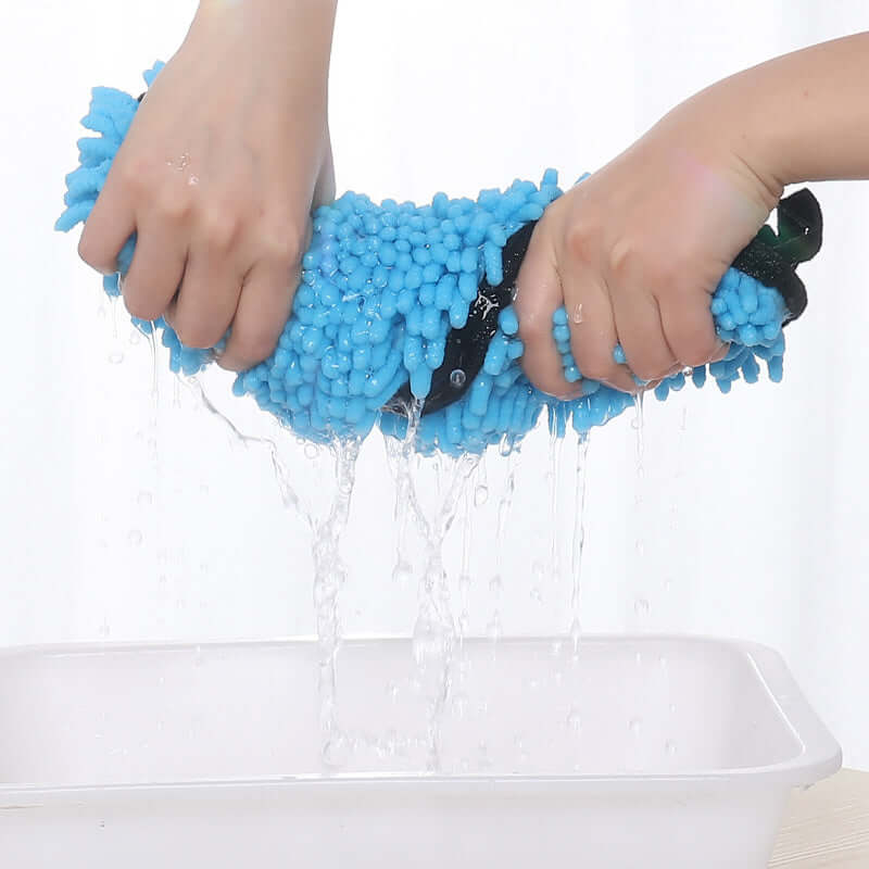 Hands squeezing a super absorbent dog bathrobe, demonstrating its water retention capabilities.