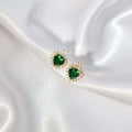 Elegant heart-shaped green earrings with gold accents, perfect for adding glamour to any outfit.