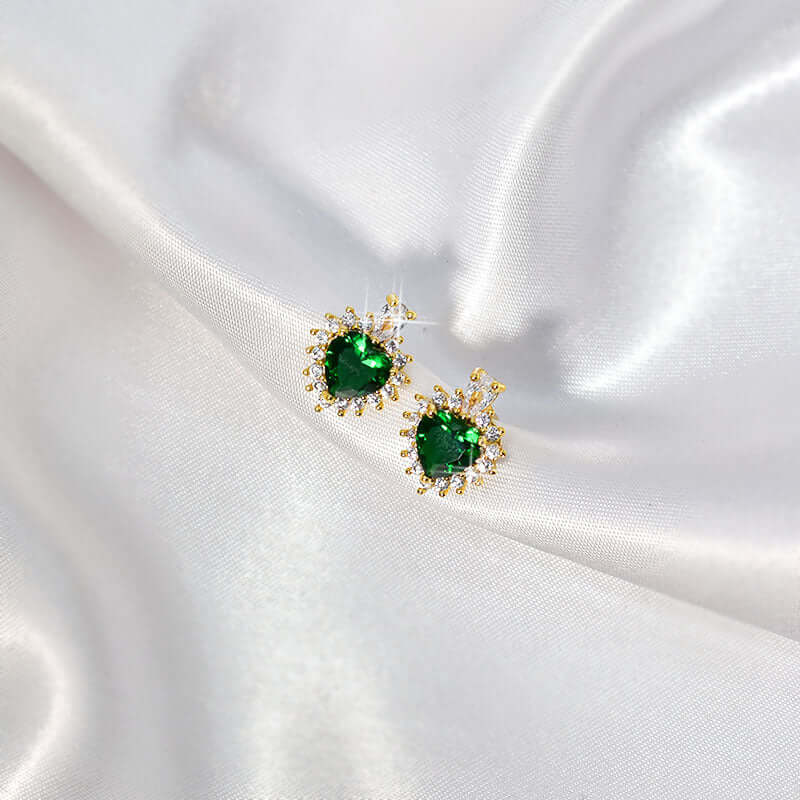 Elegant heart-shaped green earrings with gold accents, perfect for adding glamour to any outfit.