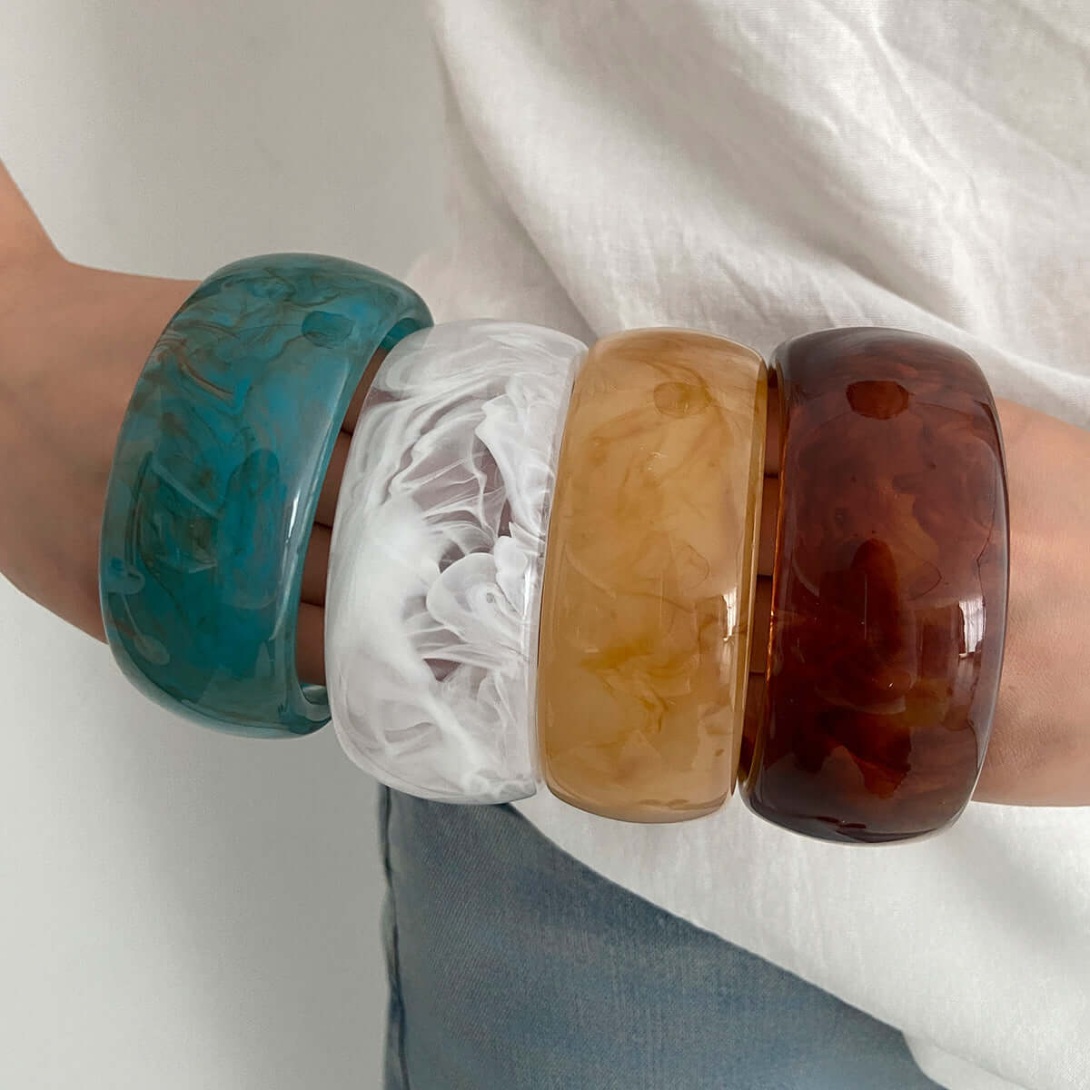 handcrafted resin-dyed bracelet stacked on wrist, showcasing vibrant colors and unique patterns