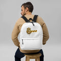 G Collection backpack water-resistant laptop bag on a man sitting on a stool, showcasing stylish design and functionality.