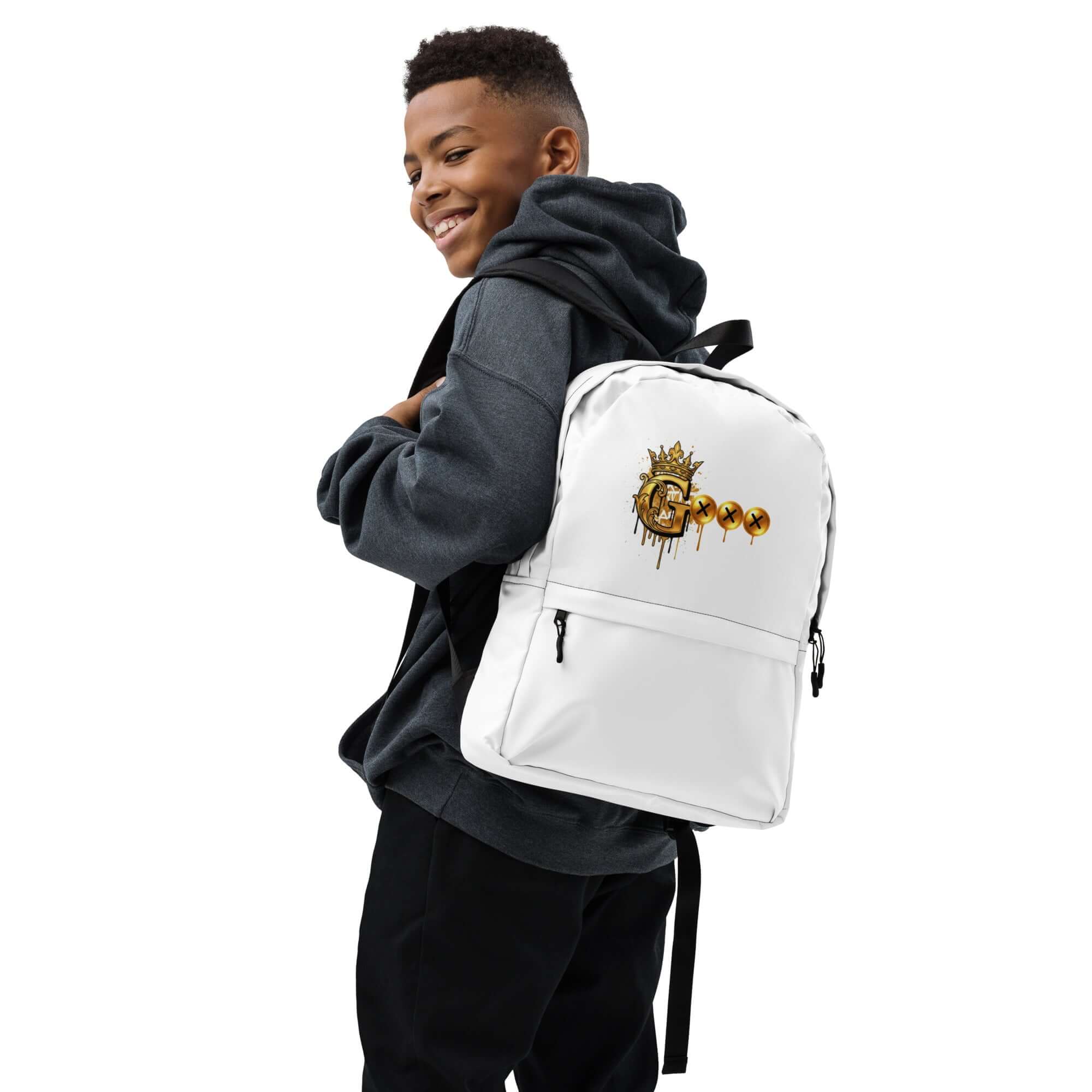 Smiling boy wearing a gray hoodie, holding a white G Collection backpack with gold logo, ideal for kids.