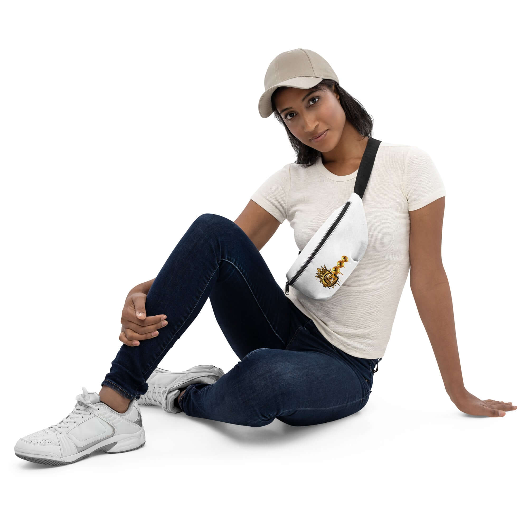 Stylish fanny pack for travel worn by a model sitting casually in a cap and casual outfit.