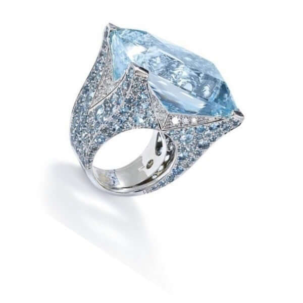 Blue square ring for women featuring a large blue gemstone and intricate sparkling details.