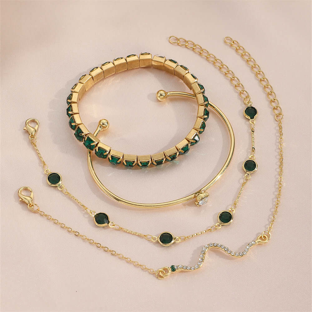 Stylish snake bracelets showcasing unique designs with gold and green accents on a soft background.