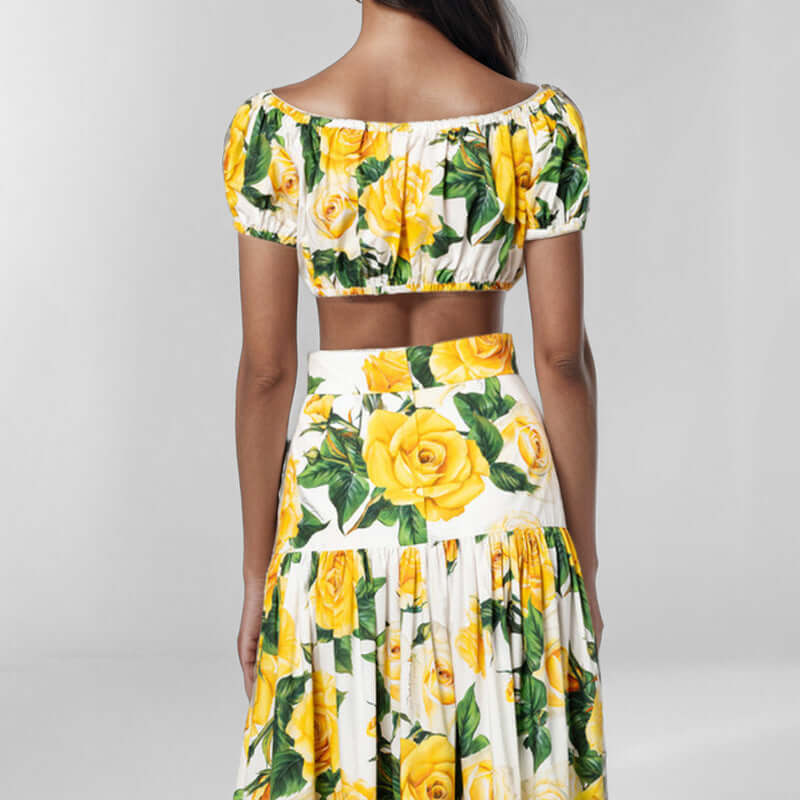 Back view of women's printed skirt two-piece outfit featuring yellow floral design.
