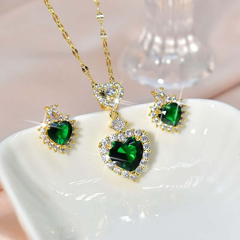Layered women's necklace set with green heart-shaped stones in a coordinated earring and pendant design.