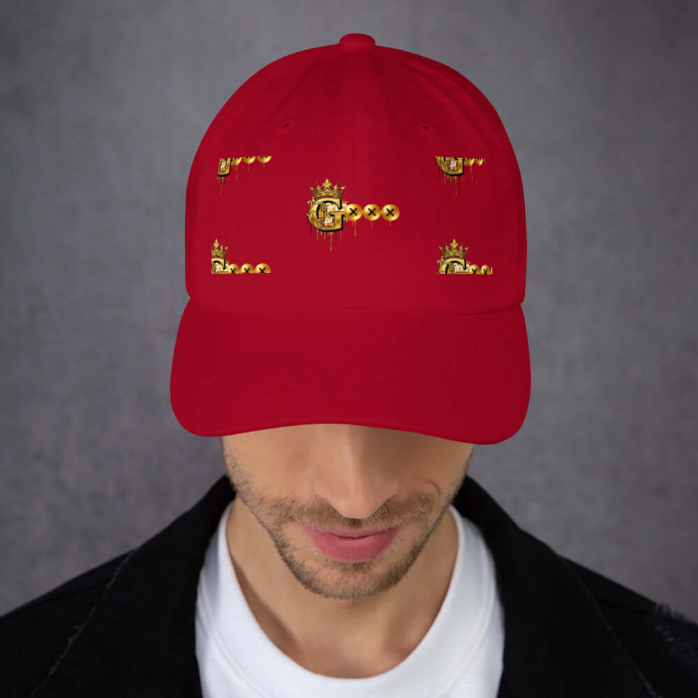Red low profile dad hat with unique golden graphic design and curved visor, perfect for casual wear.