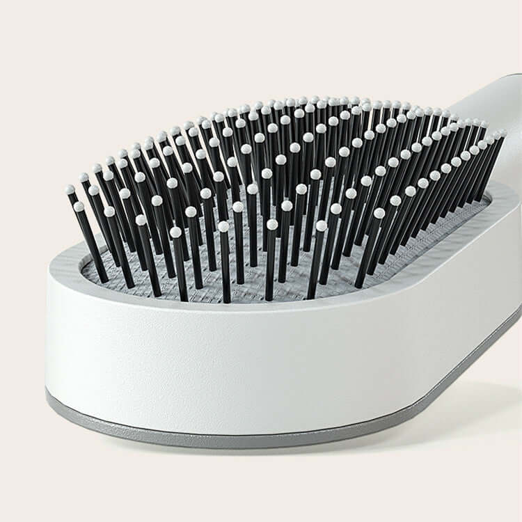 Close-up of a self-cleaning hairbrush featuring a 3D air cushion design for pain-free brushing.
