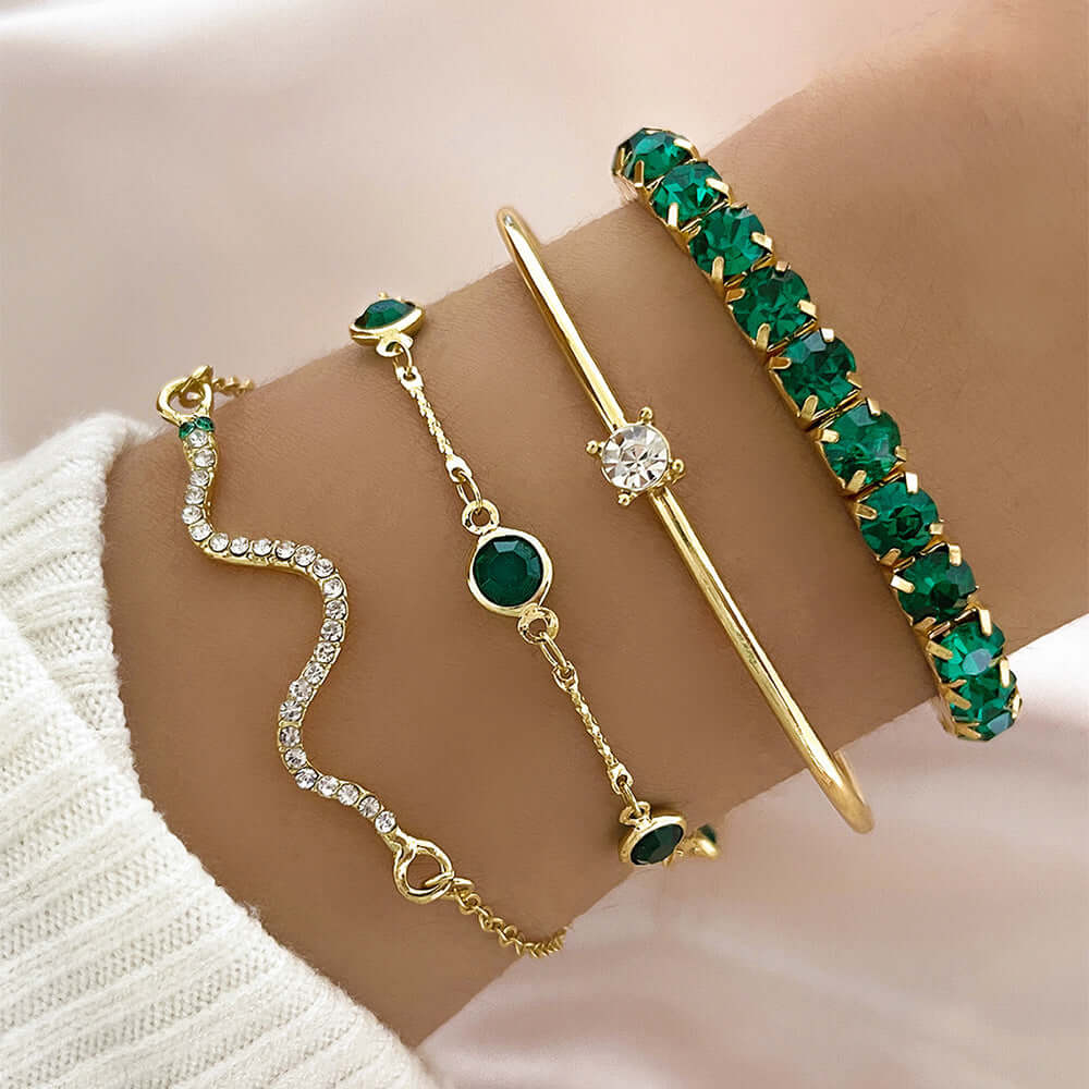 Stylish snake bracelets set featuring four designs with green accents and gold detailing, perfect for any occasion.