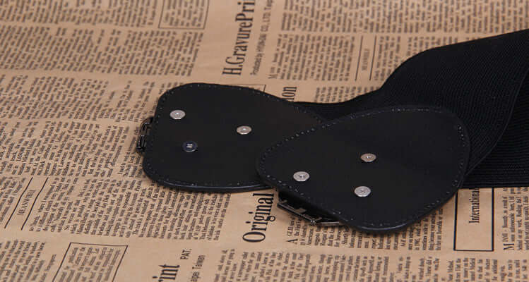 Slim women's waist belt details on vintage newspaper background, perfect for dresses and outfits.
