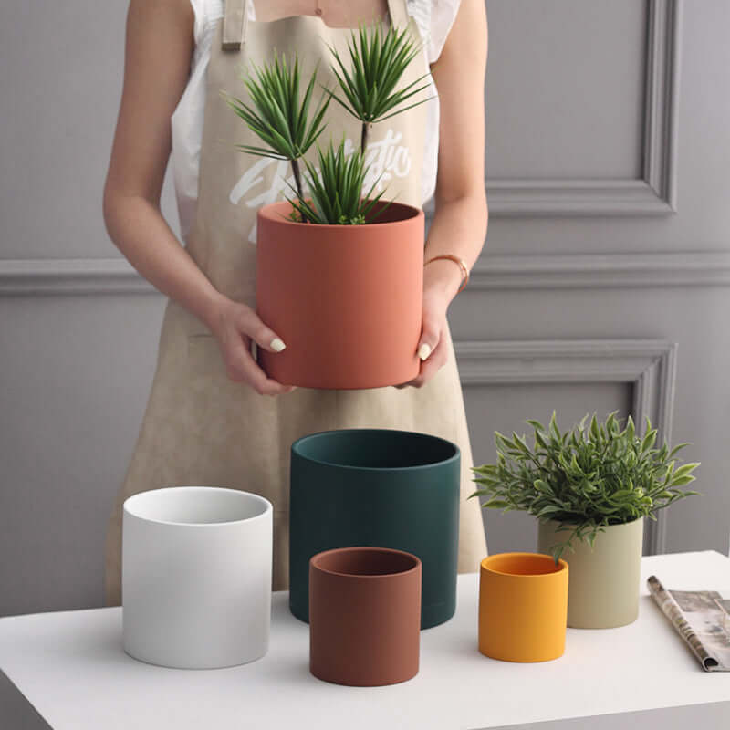 Nordic ceramic flowerpot with drainage hole in various sizes and colors, perfect for indoor and outdoor plants.