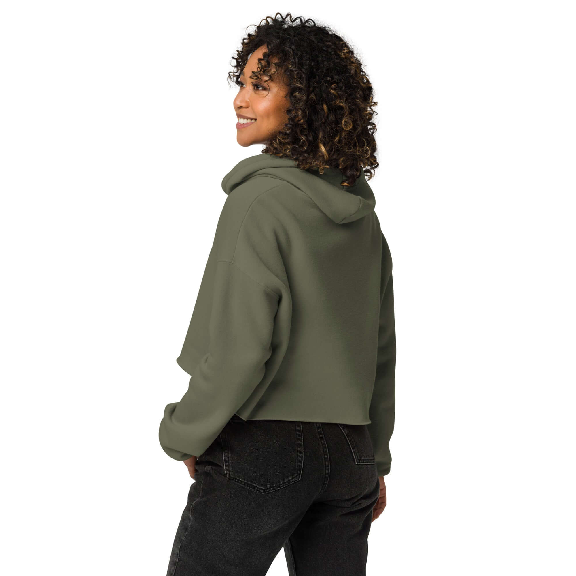 Trendy crop hoodie featuring a raw hem, dropped shoulders, and matching drawstrings, worn by a curly-haired woman.